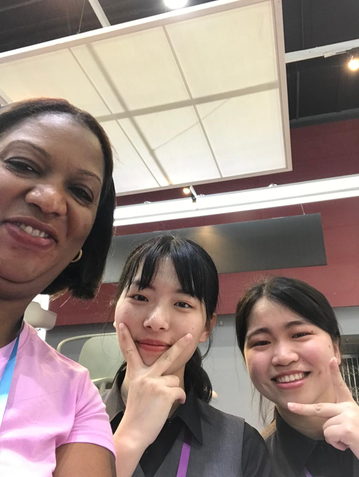 Three travelers taking a selfie together indoors